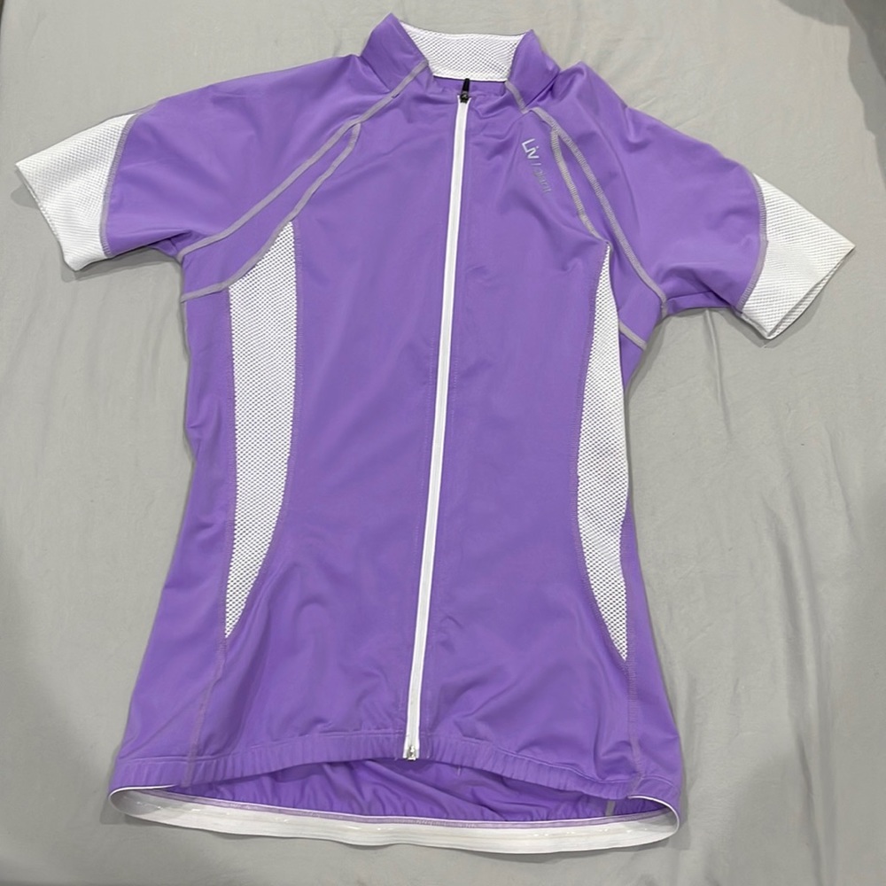 Women XS biking fitted shirt. Very breathable and has three pockets in the back.